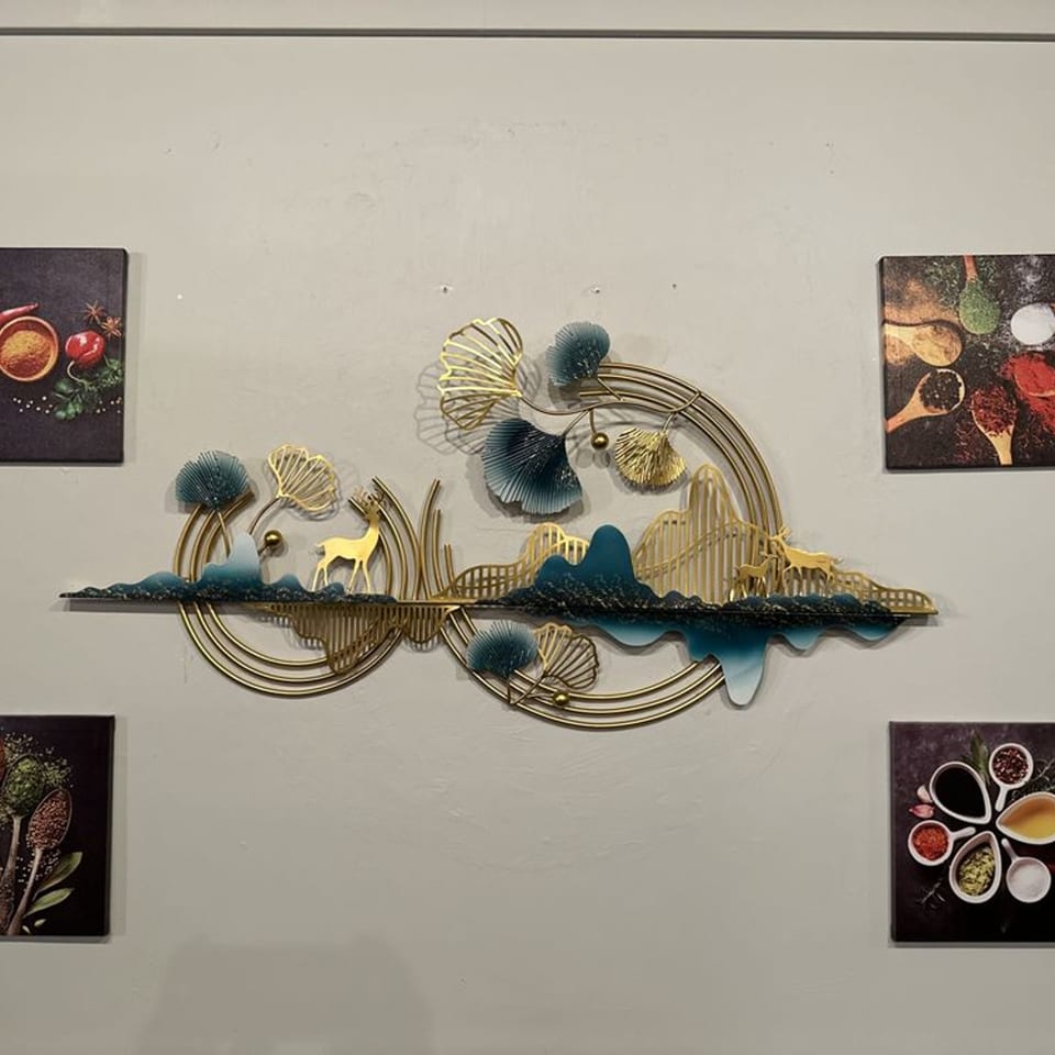 Gold and teal metal wall art with deer and abstract landscape, surrounded by spice-themed pictures.